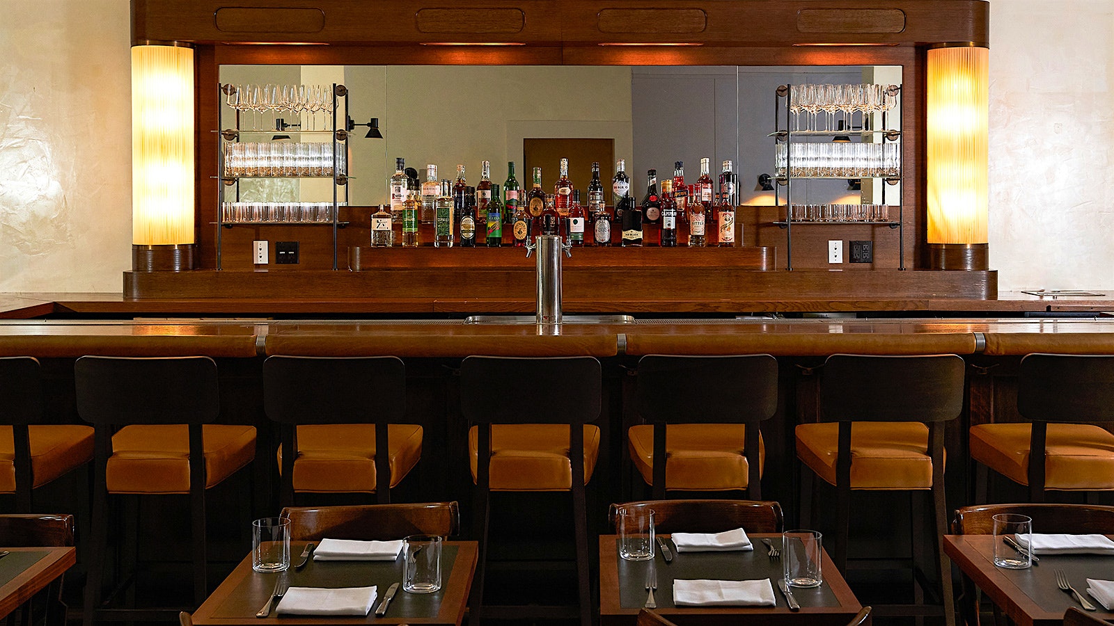 The wooden, m mirror-backed bar and dining tables at the Noortwyck